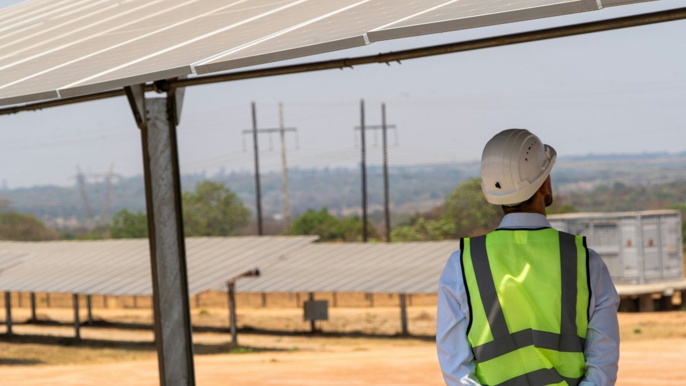Solar panels installed on a rooftop under clear sunny sky in Jaipur