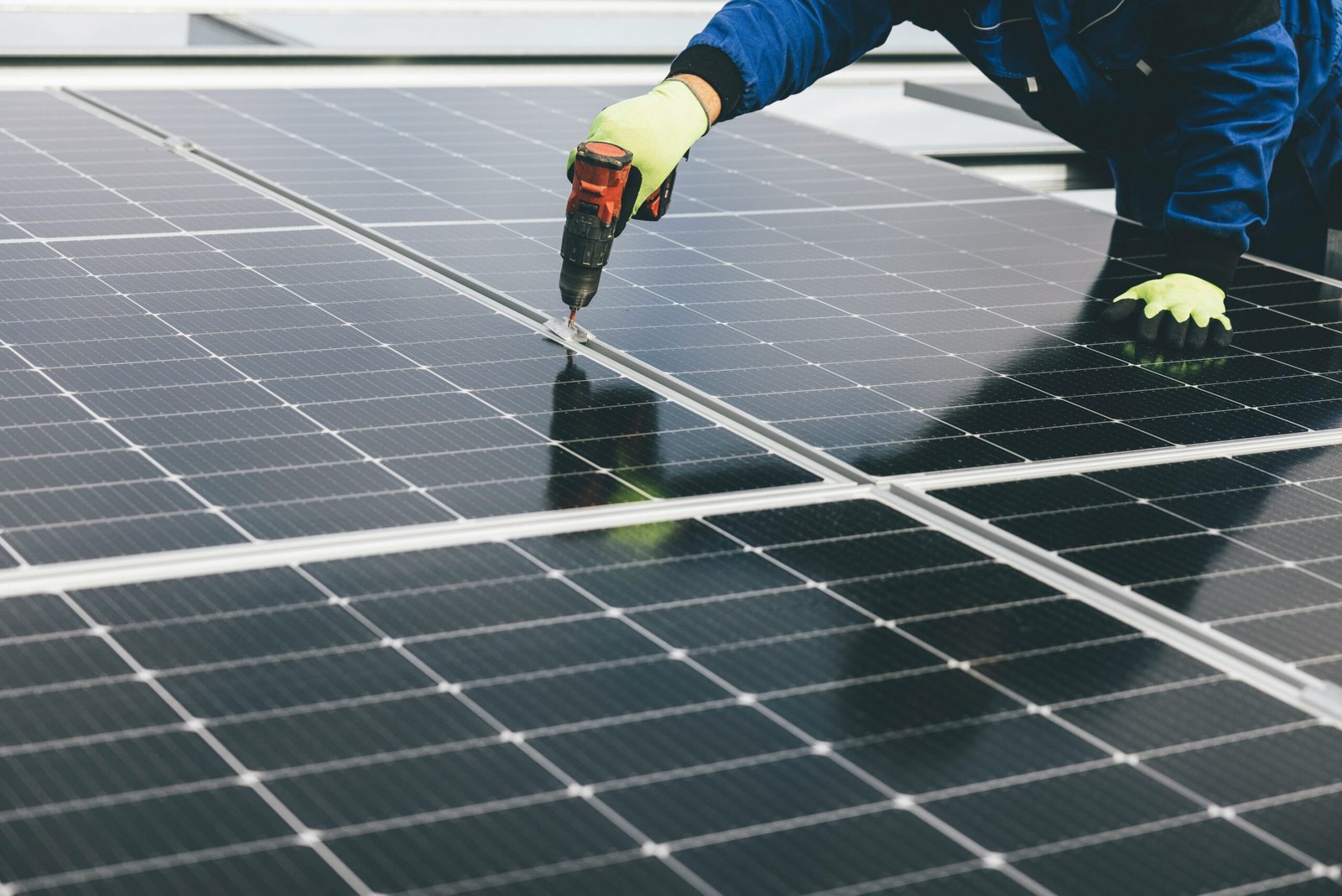 olar panel installers securing panels on a rooftop with tools