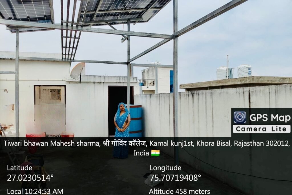 Poonam Dhakad beneath 5kW rooftop solar panels at Tiwari Bhawan, Khora Bisal, Rajasthan – empowering homes with clean solar electricity, installed by GreatSun Power, 2025