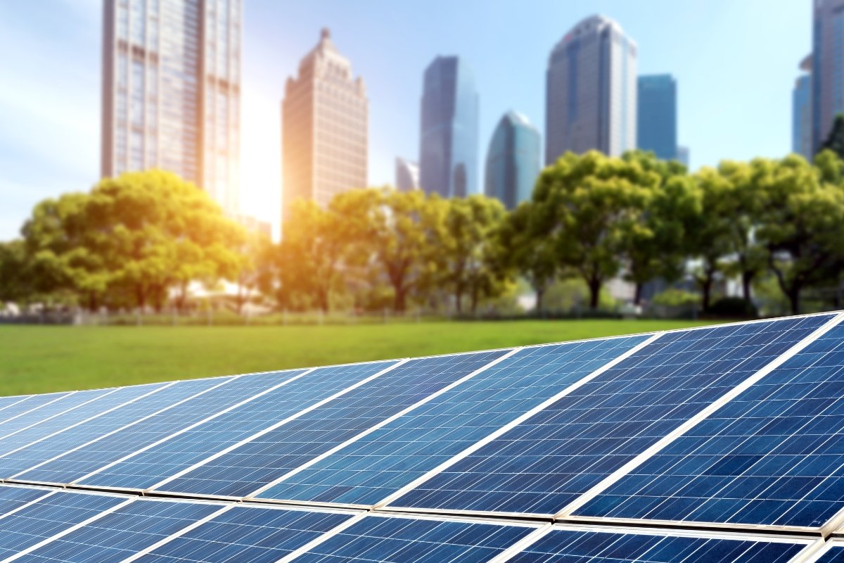 Commercial solar panels installed in Jaipur city with skyscrapers in the background — GreatSun Power